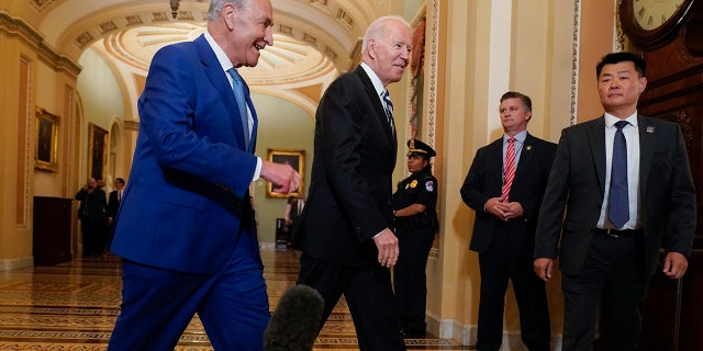 President Biden, center, walks with Senate Majority Leader Chuck Schumer, D-N.Y., at the Capitol in Washington July 14th, 2021.