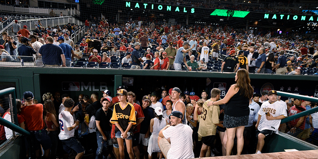 Fans are seen at Nationals Park after Saturday's game was delayed after the sound of gunfire. (Associated Press)