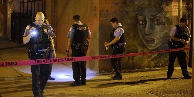 Chicago Police officers investigate the crime scene where a man was shot in the alley in the Little Village neighborhood on July 2, 2017 in Chicago, Illinois. A South Carolina sheriff’s deputy was shot and an armed suspect was killed in July, authorities said.