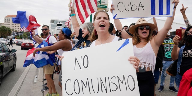 Cuban exiles rally at Versailles Restaurant in Miami's Little Havana neighborhood in support of protesters in Cuba on Monday in Miami. Sunday's protests in Cuba marked some of the biggest displays of antigovernment sentiment in the tightly controlled country in years. (AP Photo/Marta Lavandier)