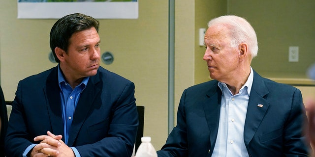 President Biden, right, looks at Florida Gov. Ron DeSantis, left, during a briefing with first responders and local officials in Miami, Thursday, July 1, 2021, on the condo tower that collapsed in Surfside, Fla.