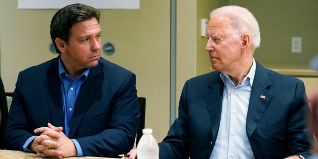 President Joe Biden (right) looks at Florida Gov. Ron DeSantis at a condominium tower that collapsed last week in Surfside, Florida, Thursday, July 1, 2021. 