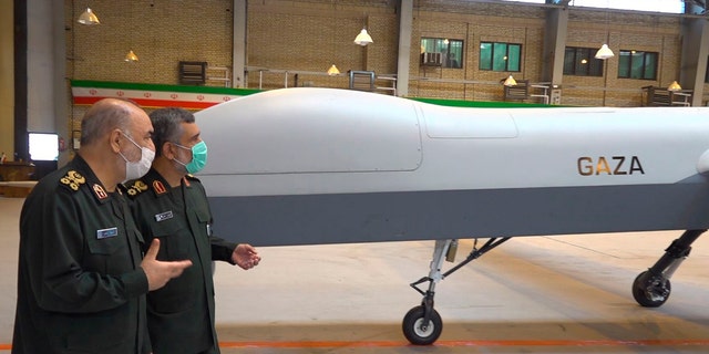 Iranian Revolutionary Guard Commander Gen. Hossein Salami, left, and the Guard's aerospace division commander Gen. Amir Ali Hajizadeh talk while unveiling a new drone called "Gaza" in an undisclosed location in Iran.