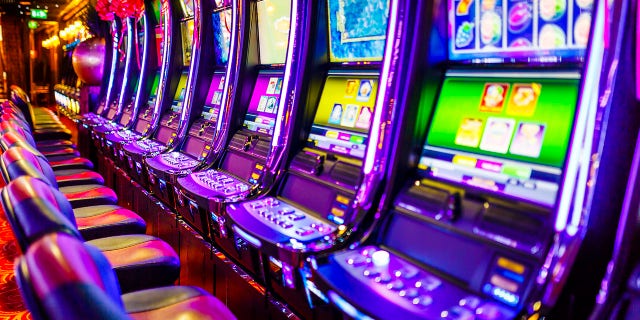 A row of slot machines inside a casino.