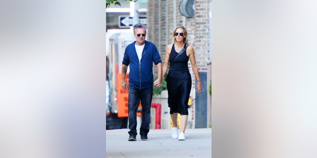 Mellencamp holds the hand of his new real estate girlfriend Natasha Barrett in Tribeca.