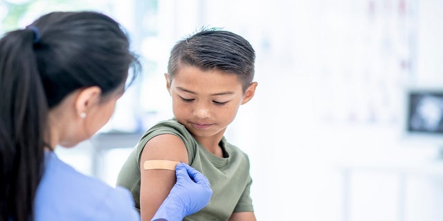 Young child receives a vaccine since the CDC and FDA approved the COVID-19 vaccine.