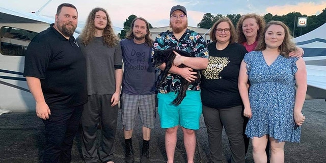 The Howard family reuniting with Razzle after 10 years. Pictured from left to right: Aaron Howard, Simon Howard, Jeremy Wade, Seth Howard, Rhonda Howard, Vickey Langley, Seth’s wife, Elizabeth.