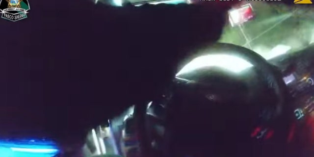 Bodycam video shows a deputy returning fire through the windshield of his patrol vehicle,