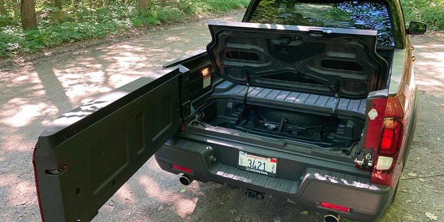 The Honda Ridgeline's tailgate opens like a door for easy access to its In-Bed trunk.