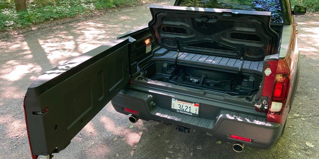 The Honda Ridgeline's tailgate opens like a door for easy access to its In-Bed trunk.
