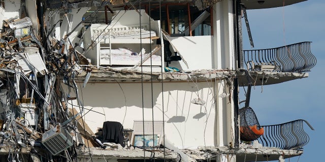 Furniture sits perched in the remains of apartments sheared in half, in the still standing portion of the Champlain Towers South condo building, more than a week after it partially collapsed. (AP)