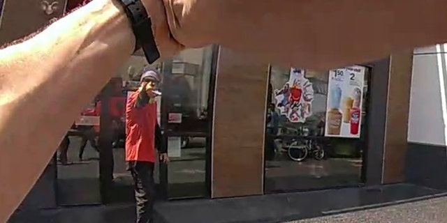 A suspect is seen pointing an object toward a police officer along the Hollywood Walk of Fame, July 15, 2021. (Los Angeles Police Department)