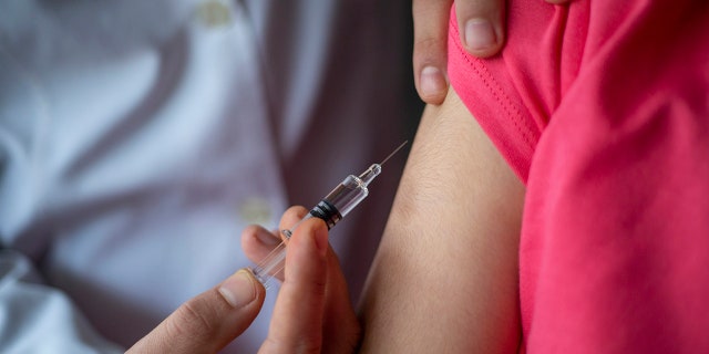 Doctor giving child patient injection