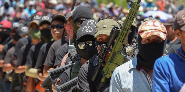 Vigilants of "El machete" As they call themselves, an armed group composed mainly of indigenous people to defend themselves against drug cartels, is seen at a meeting with indigenous communities in Pantelho, Mexico on July 18.