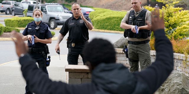 Ken Westphal, center, an officer with the Lacey Police Department and an instructor at the Washington state Criminal Justice Training Commission, works with cadets LeAnne Cone, of the Vancouver Police Department, and Kevin Burton-Crow, right, of the Thurston County Sheriff's Department, during a training exercise Wednesday, July 14, 2021. 