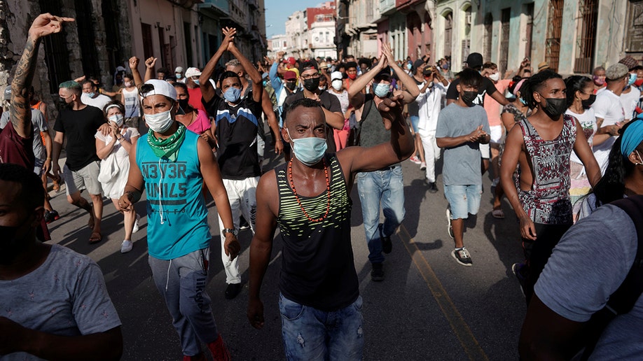 People shout slogans against the government during a protest against and in support of the government, amidst the coronavirus disease (COVID-19) outbreak, in Havana, Cuba July 11, 2021. REUTERS/Alexandre Meneghini