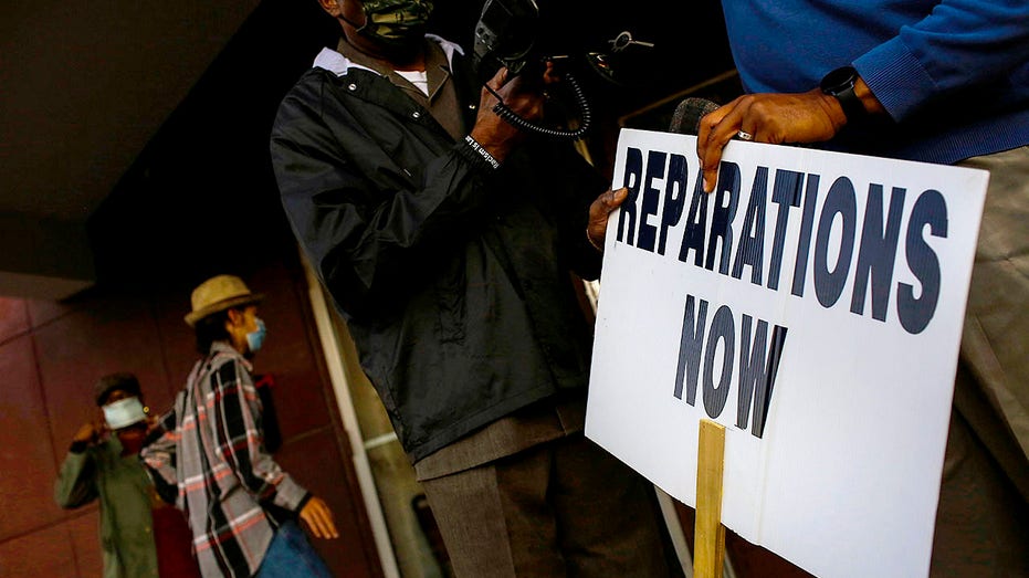 Vernon AME Church pastor Robert Turner holds a 