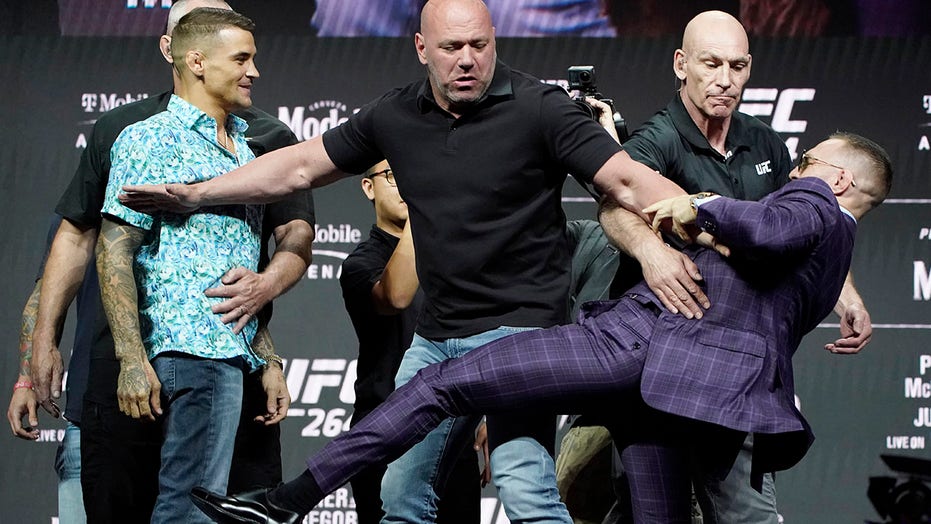 Conor McGregor attempts to kick Dustin Poirier at UFC 264 press conference