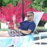 Scott Disick waves at girlfriend Amelia Gray and his three kids while sipping poppi prebiotic soda poolside at The Poppi House in the Hamptons on July 15, 2021.