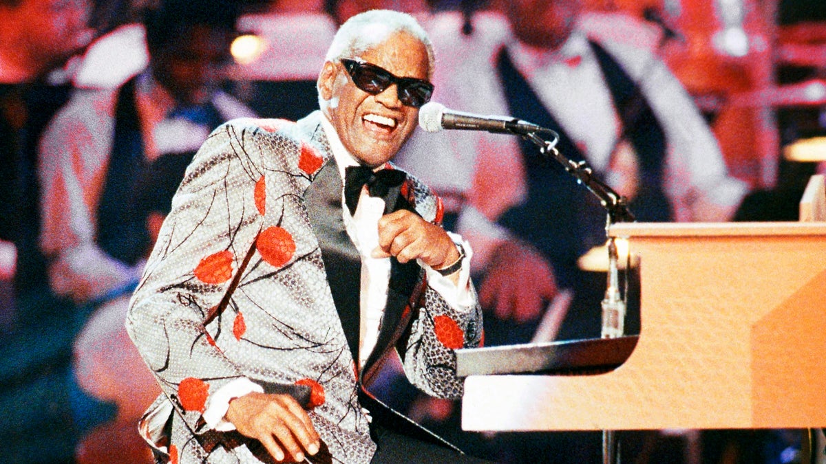 FILE - Ray Charles, performs during the taping of 'Ray Charles: 50 Years in Music, uh-huh,' a benefit musical gala for Starlight/Starbright Foundation in Pasadena, Calif. on Sept. 20, 1991. Charles will be inducted into the Country Music Hall of Fame. (AP Photo/Kevork Djansezian, File)