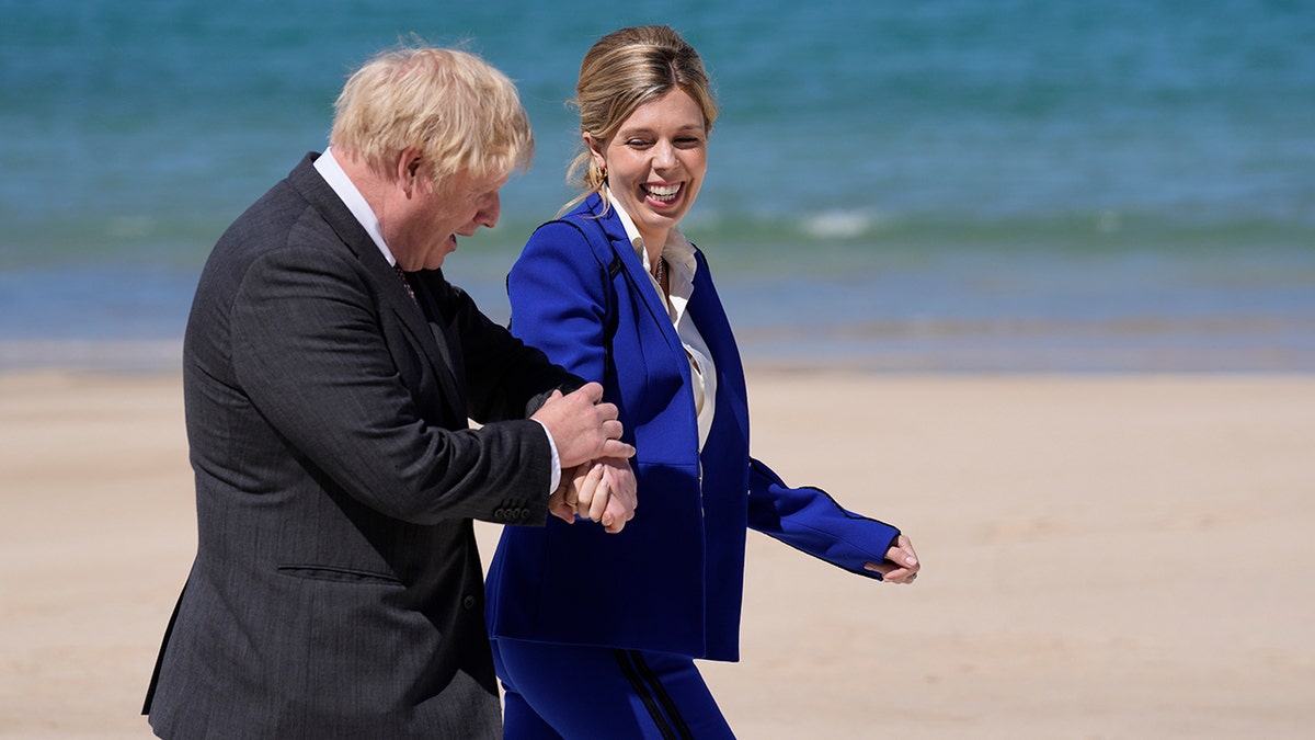 British Prime Minister Boris Johnson and wife Carrie walk during G7 meeting in St. Ives, England