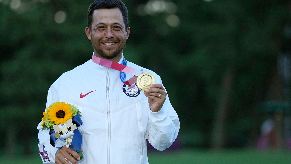 Xander Schauffele, of the United States, holds his gold medal in the men's golf at the 2020 Summer Olympics