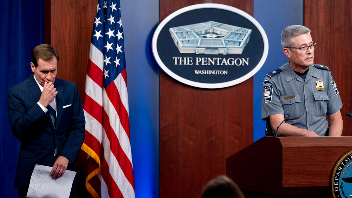 Pentagon Police Chief Woodrow Kusse, right, accompanied by Pentagon spokesman John Kirby, left, speaks during a briefing at the Pentagon in Washington, Tuesday, Aug. 3, 2021.