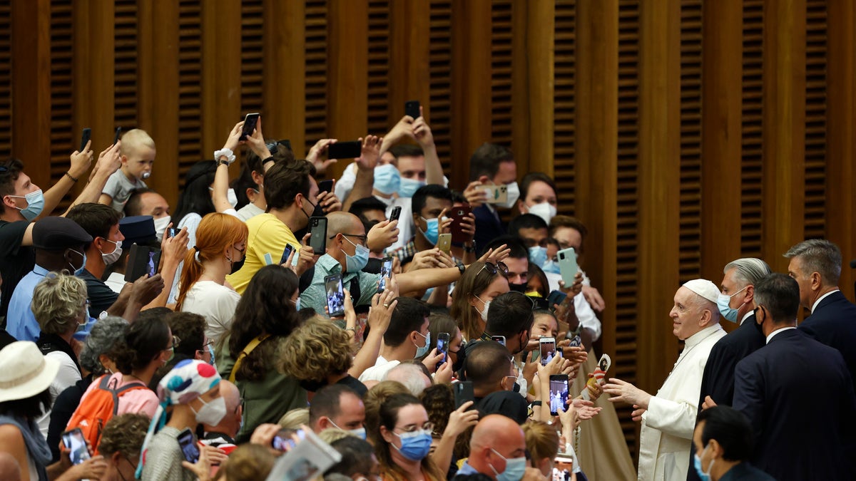 Pope Francis greets the faithful at the end of his weekly general audience in the Paul VI hall at the Vatican, Wednesday, Aug. 4, 2021. Pope Francis on Wednesday resumed his routine of weekly audiences with the general public a month after he underwent bowel surgery, expressing his desire to visit someday Lebanon, as he recalled the first anniversary of the devastating Beirut port explosion. (AP Photo/Riccardo De Luca)