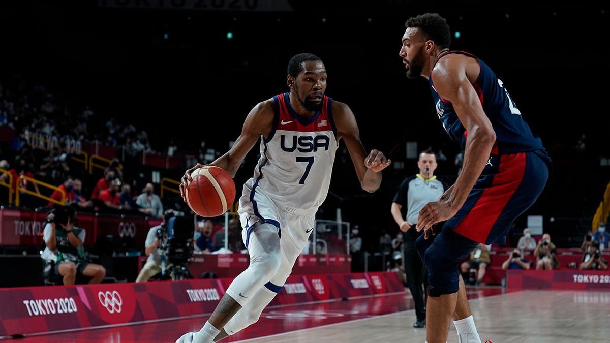 United States' Kevin Durant drives around France's Rudy Gobert during men's basketball gold medal game at the 2020 Summer Olympic