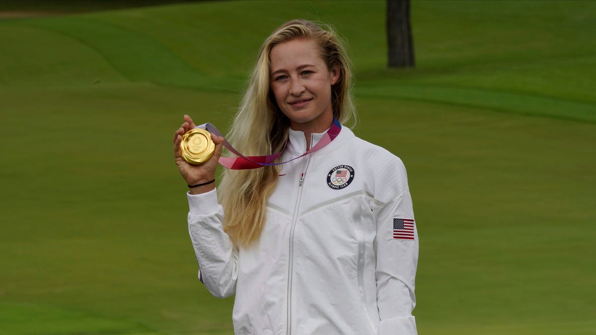 Nelly Korda, of the United States, poses with her gold medal, won in the women's golf event at the 2020 Summer Olympics