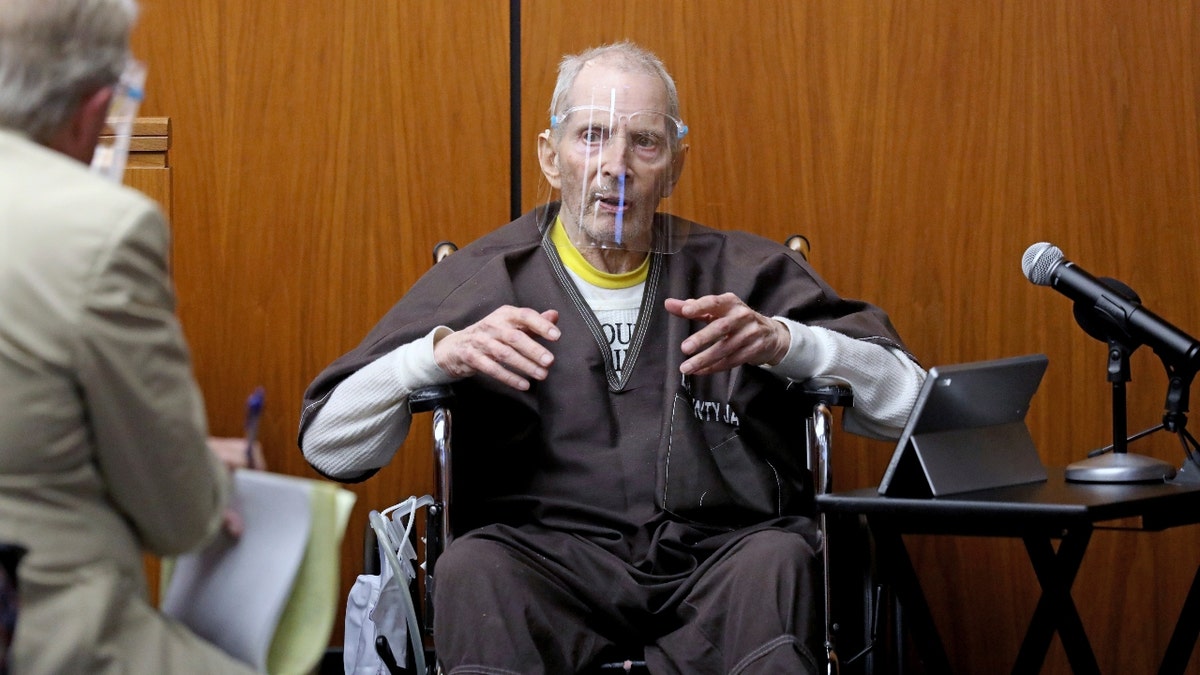 New York real estate scion Robert Durst, 78, answers questions from defense attorney Dick DeGuerin, left, while testifying in his murder trial at the Inglewood Courthouse on Monday, Aug. 9, 2021. (Gary Coronado / Los Angeles Times via AP, Pool)