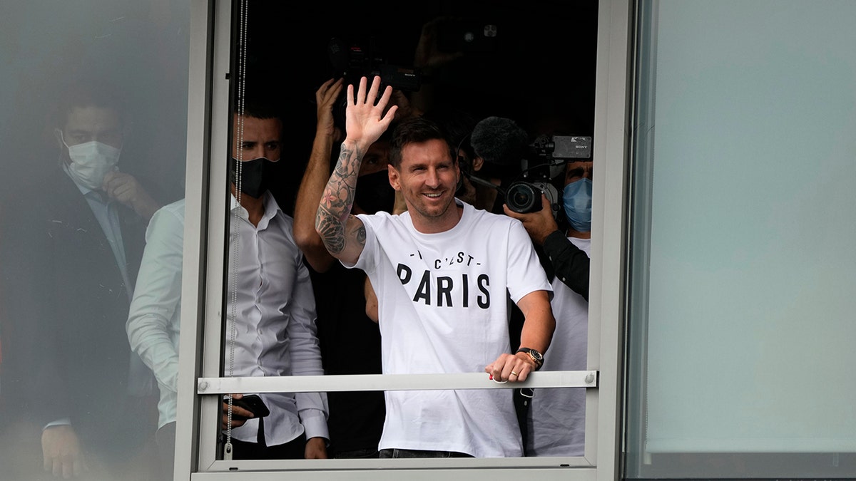 Lionel Messi waves after arriving at Le Bourget airport, north of Paris, Tuesday, Aug. 10, 2021. Lionel Messi finalized agreement on his Paris Saint-Germain contract and was flying to France on Tuesday to complete the move that confirms the end of a career-long association with Barcelona.