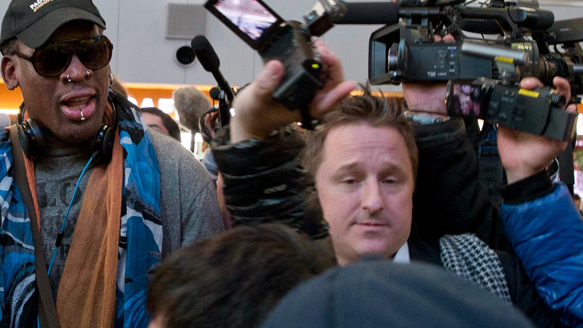 In this Dec. 19, 2013, file photo, Michael Spavor, center, an entrepreneur, is seen with former NBA star Dennis Rodman, left, on the arrival at the capital airport for a flight to North Korea in Beijing, China. The Canadian entrepreneur, who was charged with spying after his government arrested an executive of Chinese tech giant Huawei, faces a possible verdict on Wednesday, Aug. 11, 2021, as Beijing steps up pressure on Canada ahead of a court ruling on whether to hand over the executive to face U.S. criminal charges. (AP Photo/Ng Han Guan, File)