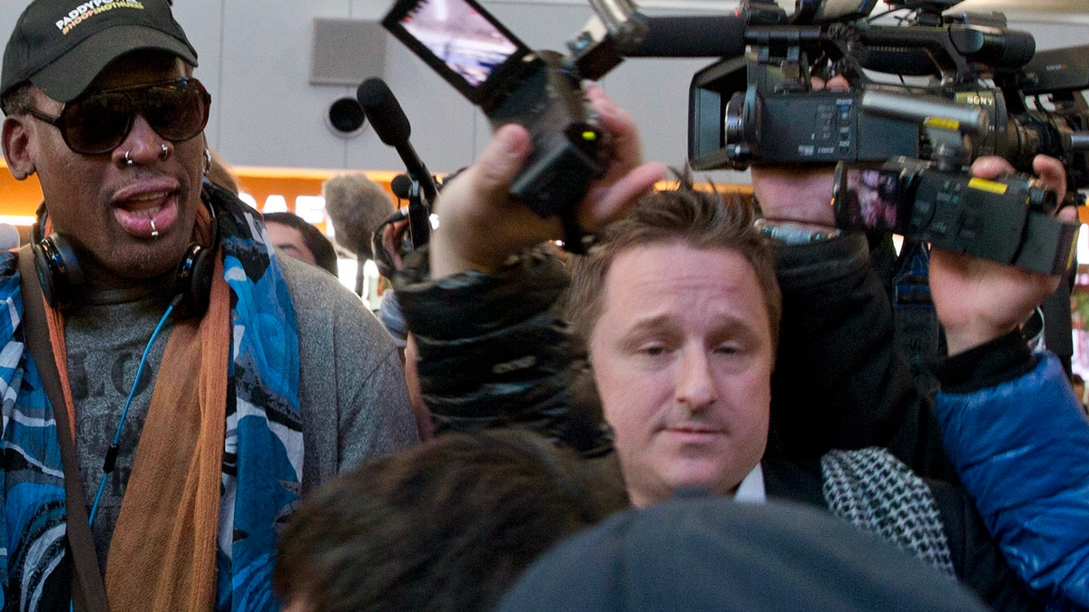 In this Dec. 19, 2013, file photo, Michael Spavor, center, an entrepreneur, is seen with former NBA star Dennis Rodman, left, on the arrival at the capital airport for a flight to North Korea in Beijing, China. The Canadian entrepreneur, who was charged with spying after his government arrested an executive of Chinese tech giant Huawei, faces a possible verdict on Wednesday, Aug. 11, 2021, as Beijing steps up pressure on Canada ahead of a court ruling on whether to hand over the executive to face U.S. criminal charges. (AP Photo/Ng Han Guan, File)