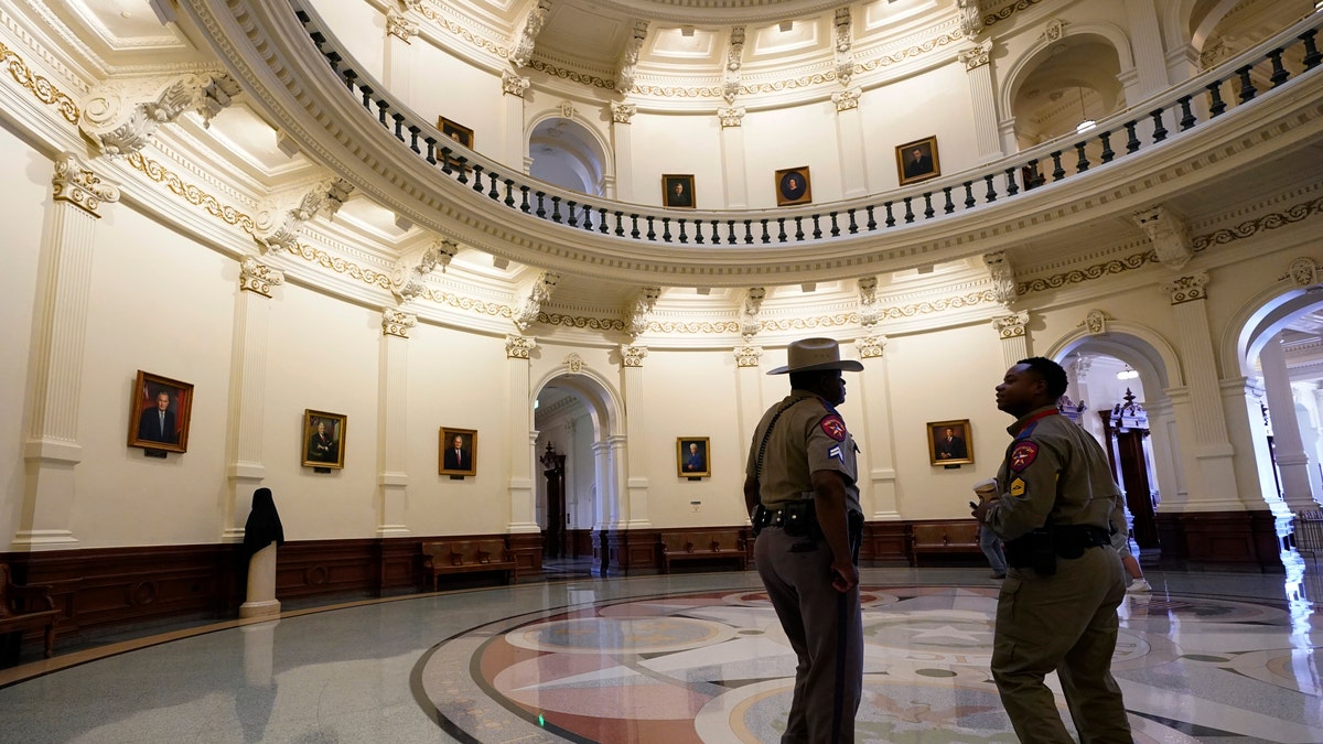 Texas Department of Safety officers stand watch over the Texas Capitol, Wednesday, Aug. 11, 2021, in Austin, Texas. Officers of the Texas House of Representatives delivered civil arrest warrants for more than 50 absent Democrats on Wednesday as frustrated Republicans ratcheted up efforts to end a standoff over a sweeping elections bill that stretched into its 31st day. (AP Photo/Eric Gay)