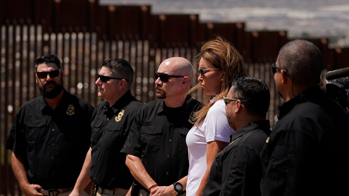 Caitlyn Jenner, center in white shirt, a Republican candidate for California governor, looks on alongside members of the National Border Patrol Council during a visit to the border Friday, Aug. 13, 2021, in San Diego. (Associated Press)