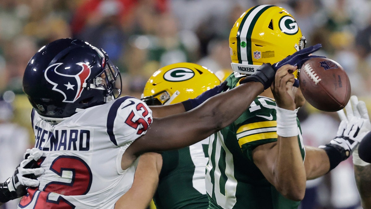 Houston Texans' Jonathan Greenard causes a fumble by Green Bay Packers' Jordan Love during a football game
