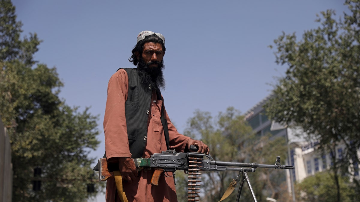 A Taliban fighter stands guard at the main gate leading to the Afghan presidential palace, in Kabul, Afghanistan, Monday, Aug. 16, 2021. The U.S. military struggled to manage a chaotic evacuation from Afghanistan on Monday as the Taliban patrolled the capital and tried to project calm after toppling the Western-backed government. (AP Photo/Rahmat Gul)