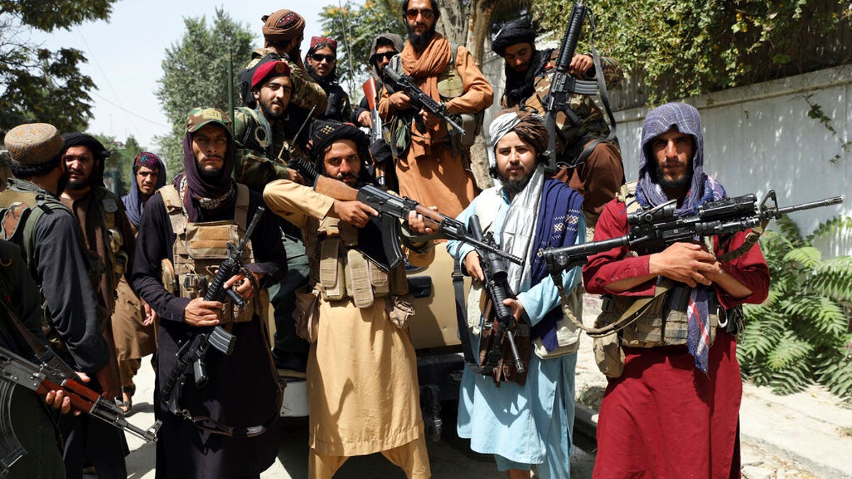 Armed Taliban fighters pose for a photograph