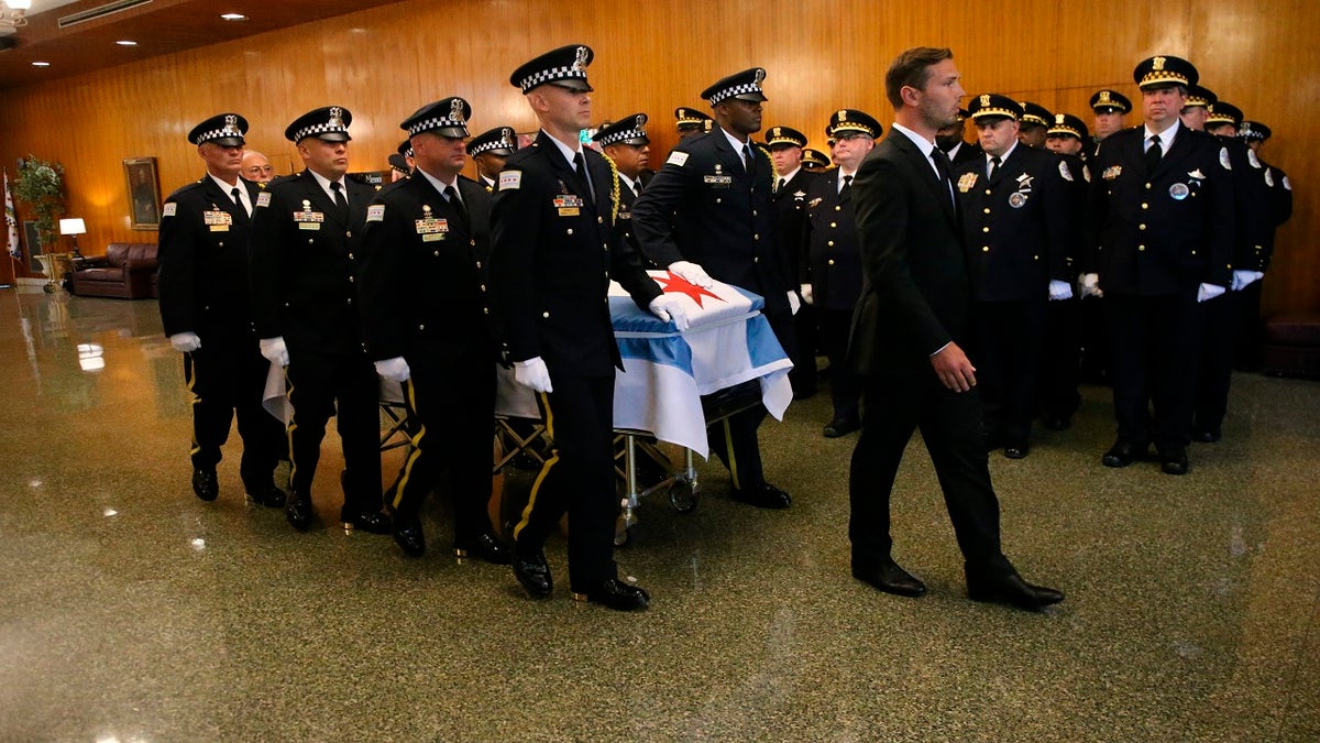 The casket of Chicago police Officer Ella French is brought through the vestibule before the funeral service for French on Thursday, Aug. 19, 2021, at St. Rita of Cascia Shrine Chapel in Chicago. French was killed and her partner was seriously wounded during an Aug. 7 traffic stop on the city's South Side.