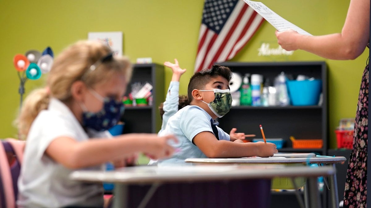 A student listens to the teacher's instructions at iPrep Academy on the first day of school on Aug. 23 in Miami. Schools in Miami-Dade County opened Monday with a strict mask mandate to guard against coronavirus infections. (AP Photo/Lynne Sladky)