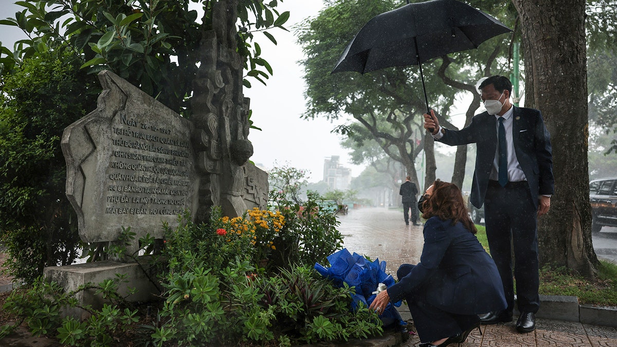 U.S. Vice President Kamala Harris lays flowers at the Senator John McCain memorial site, where his Navy aircraft was shot down by the North Vietnamese, on the three-year anniversary of his death, in Hanoi, Vietnam, Wednesday, Aug. 25, 2021. (Associated Press)