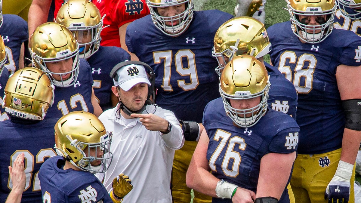 FILE - In this May 1, 2021, file photo, Notre Dame offensive coordinator Tommy Rees talks with players during a timeout in the Blue-Gold NCAA spring football game in South Bend, Ind. The 2021 challenge for Rees is to improve considerably from last season’s scoring output of 33.4 points per game. (AP Photo/Robert Franklin, File)