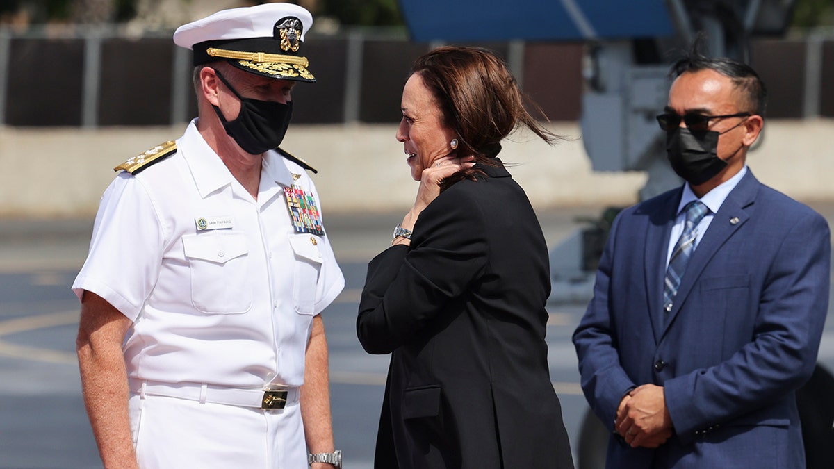 U.S. Vice President Kamala Harris is received by Adm. Samuel Paparo, left, Commander of the U.S. Pacific Fleet, as she arrives at Joint Base Pearl Harbor-Hickam, Hawaii, before continuing to Washington, Thursday, Aug. 26, 2021. (Evelyn Hockstein/Pool Photo via AP)