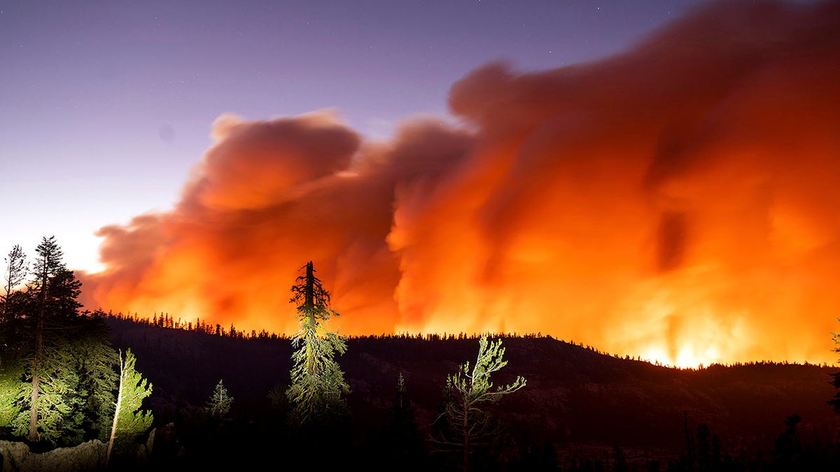 Seen in a long camera exposure, the Caldor Fire burns on Sunday, Aug. 29, 2021, in Eldorado National Forest, Calif. (AP Photo/Noah Berger)