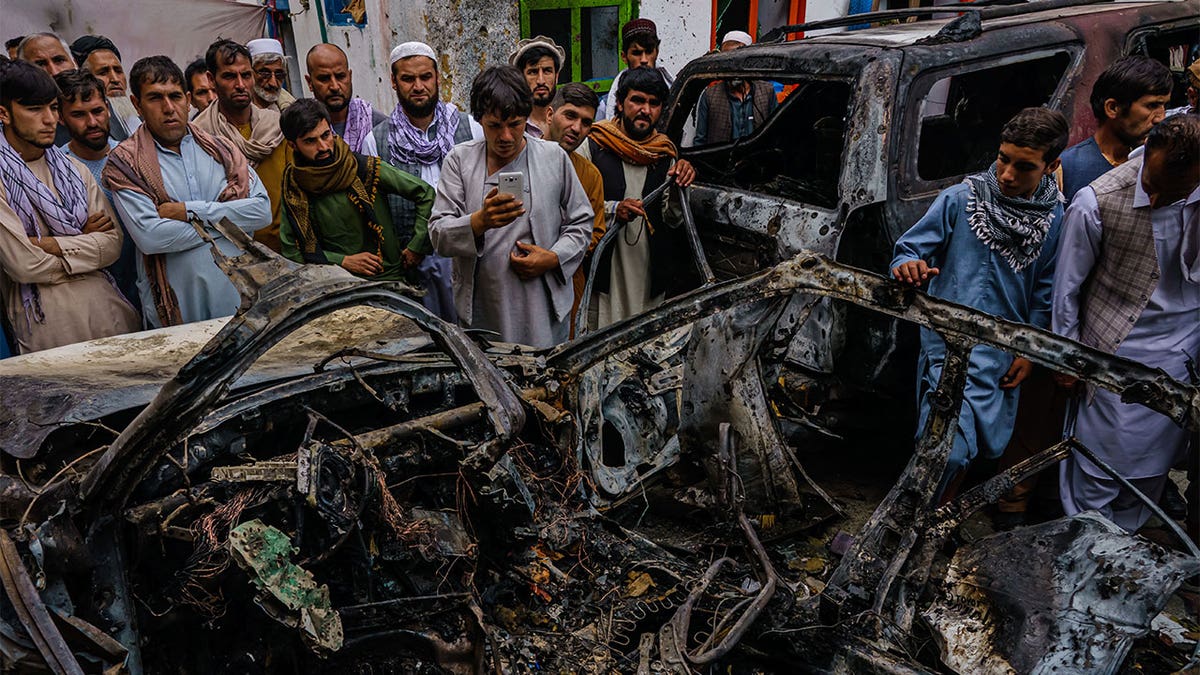 Afghans-gather-around-vehicle-in-Kabul-US-drone-strike