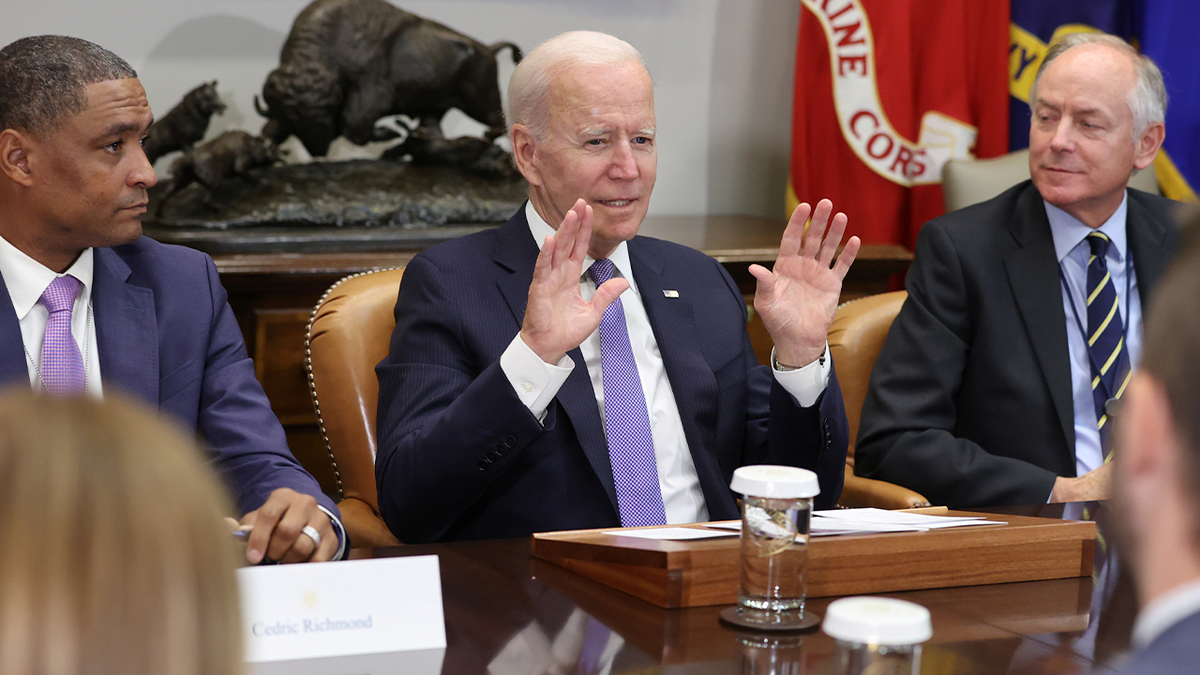 President Biden (center) speaks as former Rep. Cedric Richmond, D-LA, (left) listens at a meeting in Washington.