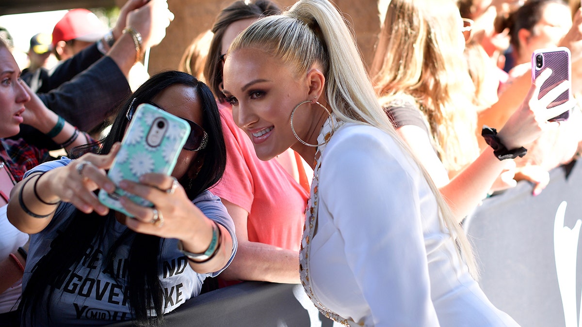 Brittany Aldean poses for a photo with a fan