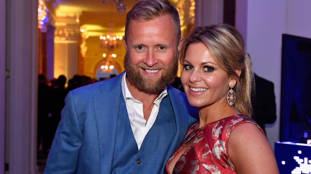 Candace Cameron Bure smiling with her husband in DC