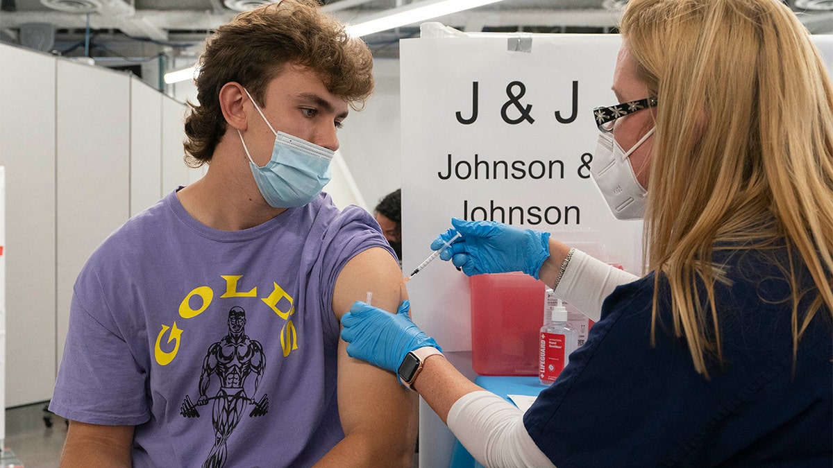 FILE — In this July 30, Bradley Sharp, of Saratoga, N.Y., gets the Johnson & Johnson vaccine from registered nurse Stephanie Wagner in New York. 